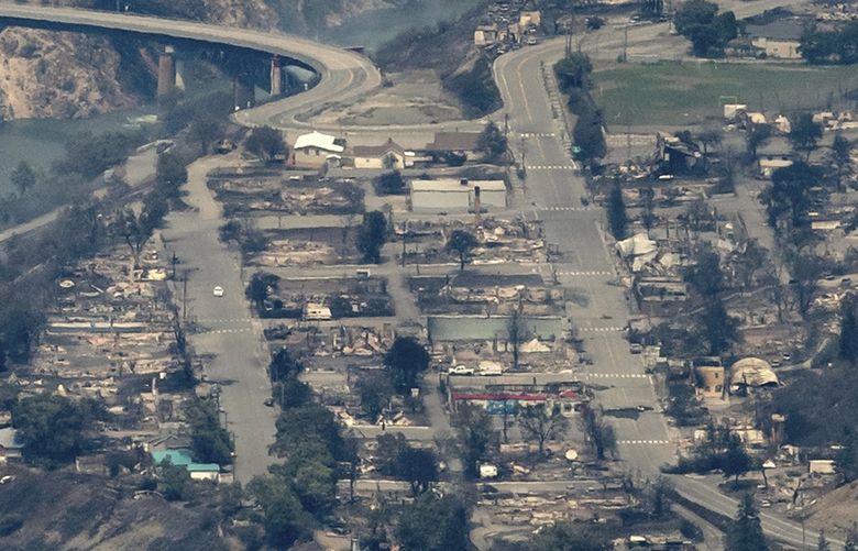 In this aerial photo taken from a helicopter, structures destroyed by wildfire are seen in Lytton, British Columbia, on Thursday, July 1, 2021. Lytton city council member Lilliane Graie, on behalf of Mayor Jan Polderman, said in an email Thursday that the fire had devastated the town, a village about 153 kilometers (95 miles) northeast of Vancouver. (Darryl Dyck/The Canadian Press via AP) VCRD113 VCRD113