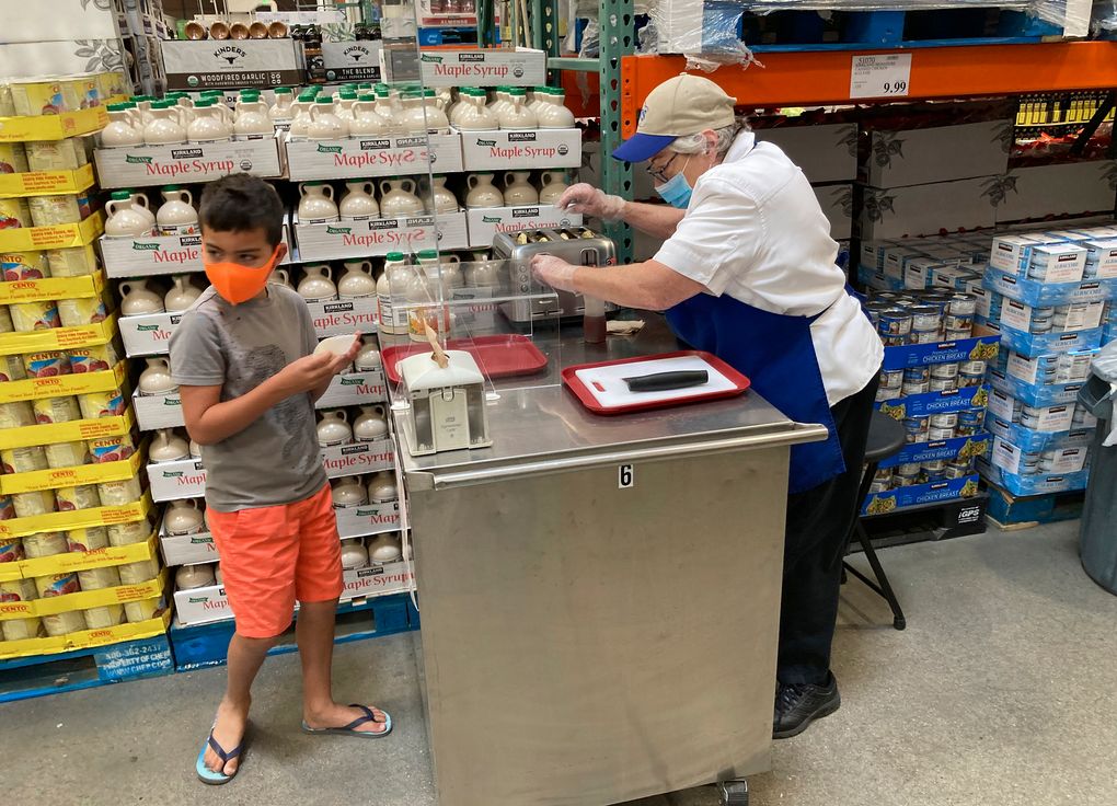 A worker offers a sample of a waffle flavored with a featured maple syrup at a Costco warehouse on June 17 in Lone Tree, Colorado. (AP Photo / David Zalubowski)