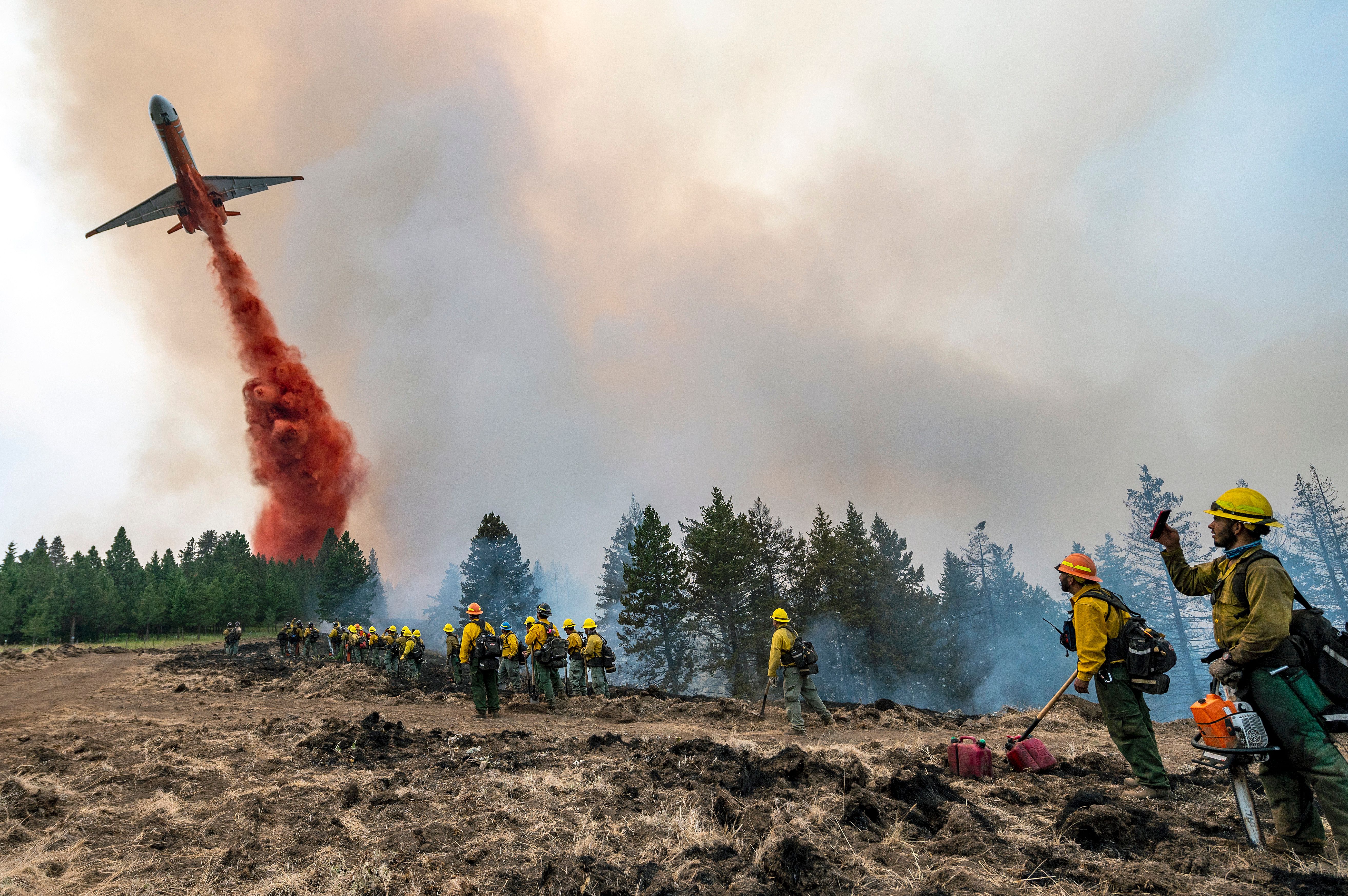 Thousands of firefighters battle big blazes across the West The