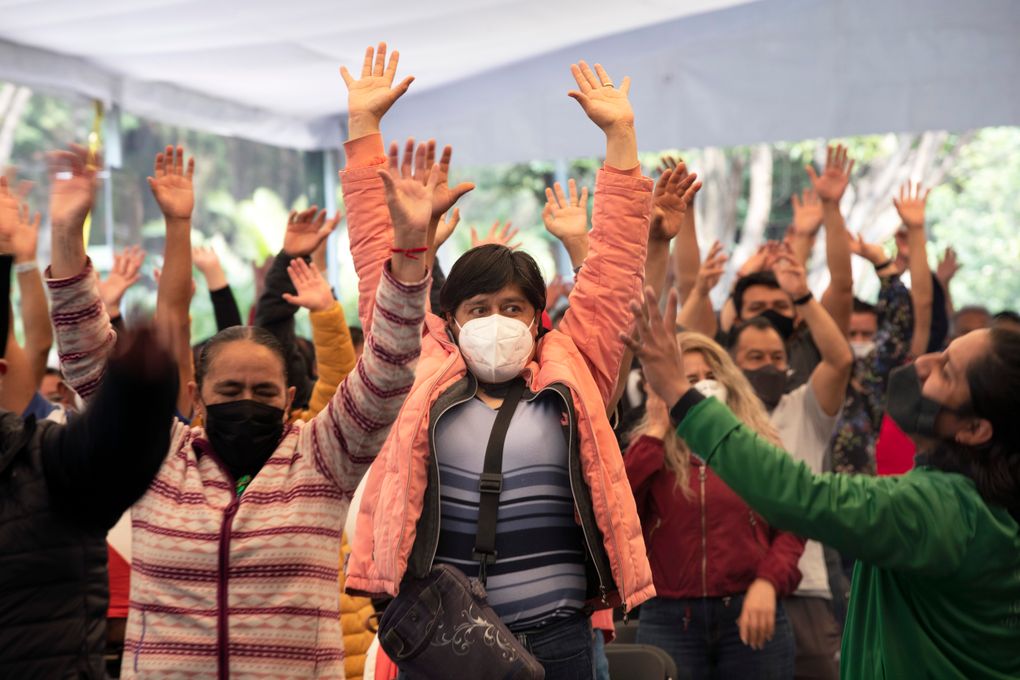 People who have just been vaccinated with the AstraZeneca COVID-19 vaccine exercise in an observation lounge during a vaccination drive for people ages 30 to 39 in Mexico City, Wednesday, July 7, 2021. (AP Photo/Marco Ugarte)