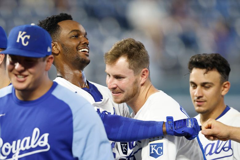 Kansas City Royals' Hunter Dozier, center, celebrates with Jorge