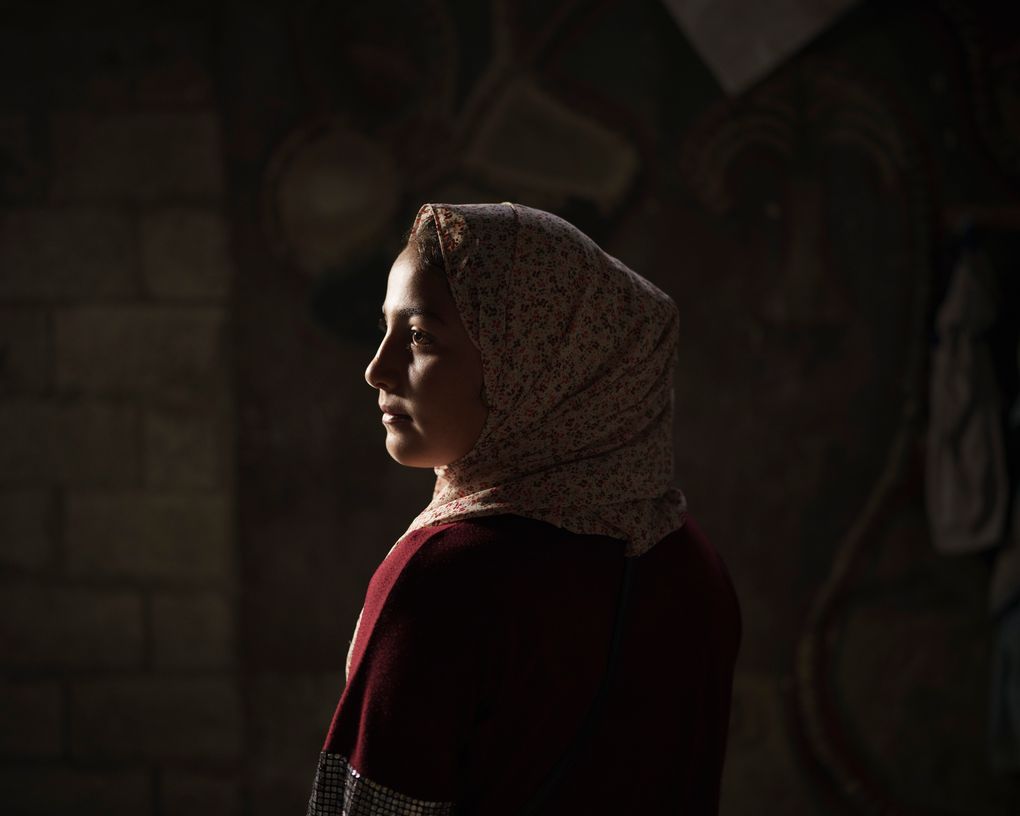 Lama Sihweil, 14, poses for a portrait in her house in Beit Hanoun, northern Gaza Strip, Sunday, June 20, 2021. When the 2014 war broke out, Lama and her family fled their home in Beit Hanoun when the Israeli army invaded, joining some 3,300 Palestinians crammed into the U.N.-run Abu Hussein school in the Jabaliya refugee camp. As they slept, Israeli shells pounded the school and the street. Three of 7-year-old Lama’s cousins — ages 14, 16 and 26 — were among the 16 killed in that attack. The 2014 war claimed more than 2,100 Palestinian lives in Gaza. (AP Photo/Felipe Dana)