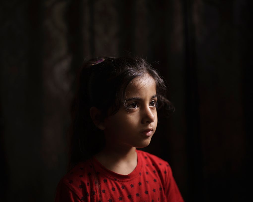 Elien al-Madhoun, 6, poses for a portrait at her grandfather’s house, where she is living after her house was destroyed during an 11-day war, in Beit Lahia, northern Gaza Strip, Saturday, June 19, 2021. Elien was not yet born when her father lost his home in the 2014 Gaza War. Young as she is, she doesn’t entirely understand life and death. But in May, she screamed out at the sounds of airstrikes and shelling in Bait Lahia in northern Gaza, says her father, Ahmed Rabah al-Madhoun. “When nine homes are completely destroyed next to one another and my daughter sees this, she can’t understand what happened,” he says. (AP Photo/Felipe Dana)