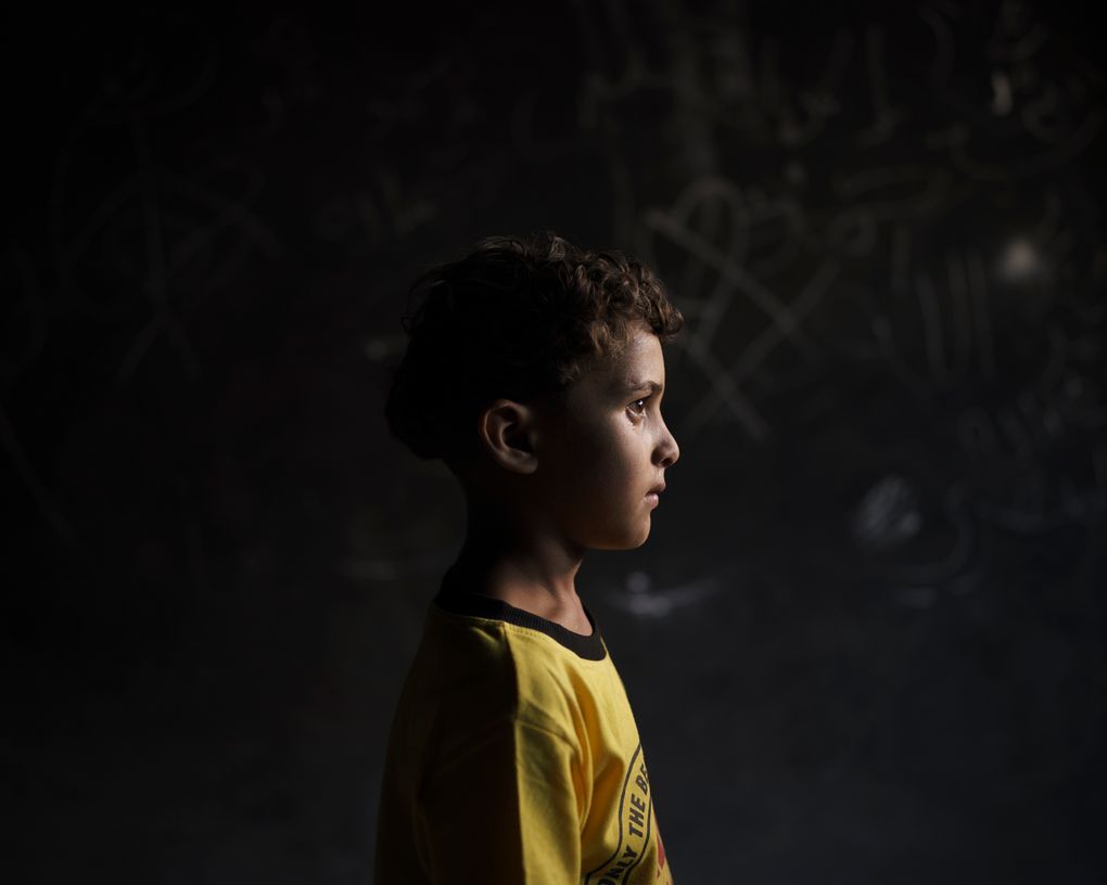 Qasim al-Masri, 6, poses for a portrait at his house in Beit Hanoun, northern Gaza Strip, on Sunday, June 20, 2021. A May 10 explosion in a field near their home killed his best friend and cousin, Marwan, 7. They’d been inseparable, even in school, his father says. Marwan’s only brother, Ibrahim, 11, also was killed. The attack “completely changed” Qasim, his father says. The young boy talks to himself. At night, he’s paralyzed by fear and does not get out of bed to use the bathroom. (AP Photo/Felipe Dana)