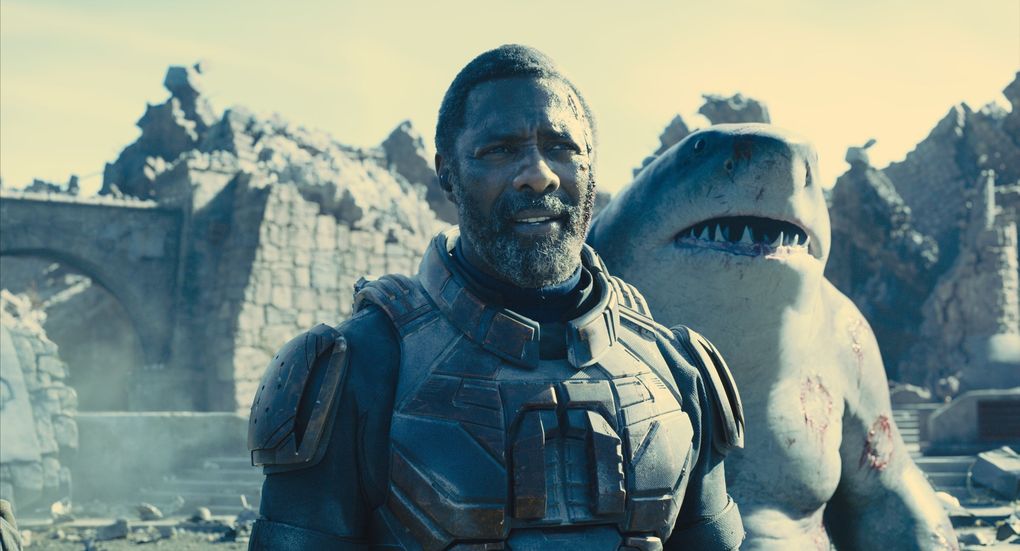Bloodsport (Idris Elba) and King Shark (mumbles and grumbles by Sylvester Stallone) in “The Suicide Squad.” (Warner Bros. Pictures / DC Comics)