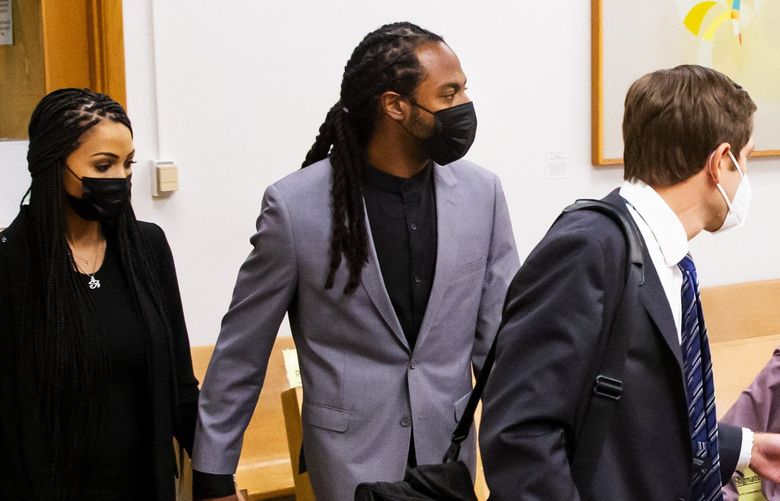Former Seahawks star Richard Sherman walks into a courtroom at the King County District Court with his wife, Ashley Moss-Sherman, and his attorney, Cooper Offenbecher, for his arraignment in Seattle Friday July 16, 2021. Sherman was charged with five misdemeanors after being arrested early Wednesday for reportedly attempting to force entry into his in-laws’ Redmond residence. He was ordered released from jail yesterday. 217670