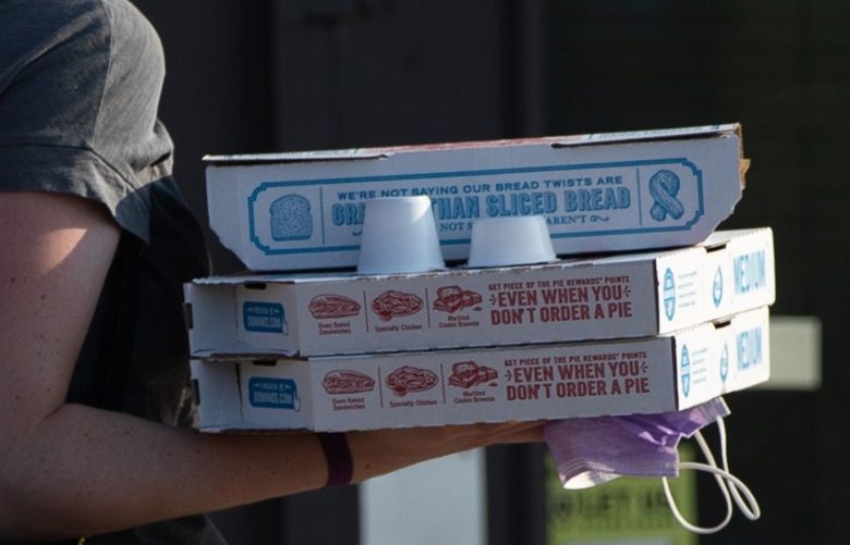 A customer carries an order to their car outside a Domino’s Pizza Inc. restaurant in Livonia, Michigan, U.S., on Thursday, July 9, 2020. Domino’s is scheduled to release earnings figures on July 16. Photographer: Emily Elconin/Bloomberg
