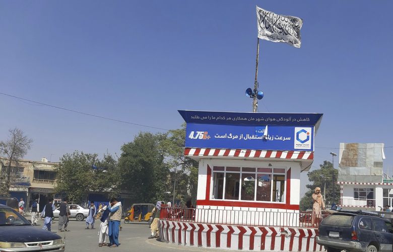 A Taliban flag flies in the main square of Kunduz city after fighting between Taliban and Afghan security forces, in Kunduz, Afghanistan, Sunday, Aug. 8, 2021. Taliban fighters Sunday took control of much of the capital of northern Afghanistan’s Kunduz province, including the governor’s office and police headquarters, a provincial council member said. (AP Photo/Abdullah Sahil) XRG111 XRG111