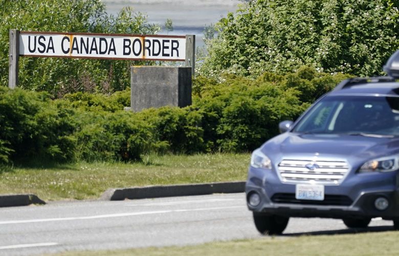 FILE – In this June 8, 2021, file photo, a car heads into the U.S. from Canada at the Peace Arch border crossing in Blaine, Wash. Canada is lifting its prohibition Monday, Aug. 9, on Americans crossing the border to shop, vacation or visit, but the United States is keeping similar restrictions in place for Canadians. The reopening Monday is part of a bumpy return to normalcy from COVID-19 travel bans.  (AP Photo/Elaine Thompson, File) FX505 FX505