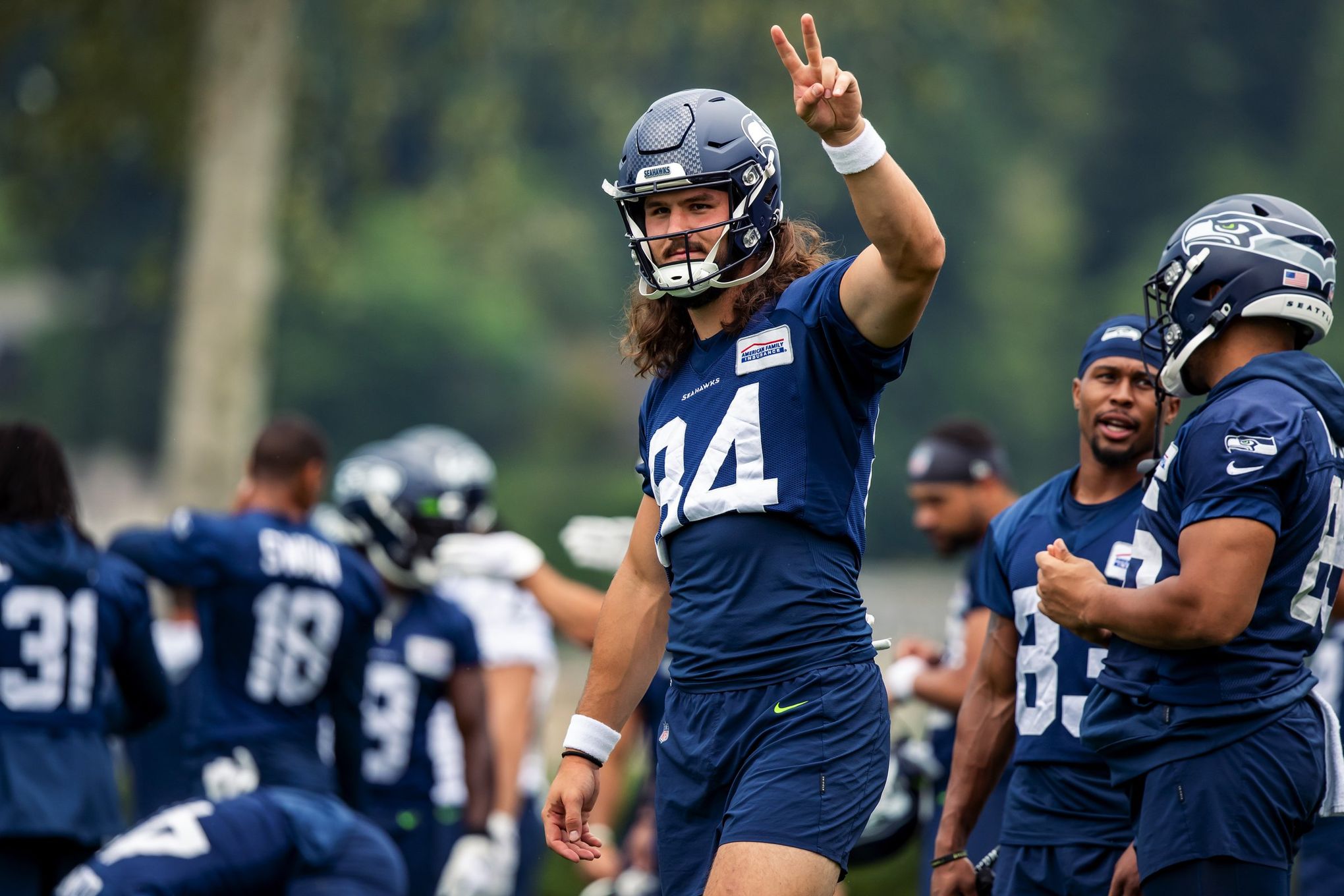 Seattle Seahawks tight end Colby Parkinson (84) puts his helmet on during  an NFL football game against the Los Angeles Chargers, Sunday, Oct. 23,  2022, in Inglewood, Calif. (AP Photo/Kyusung Gong Stock