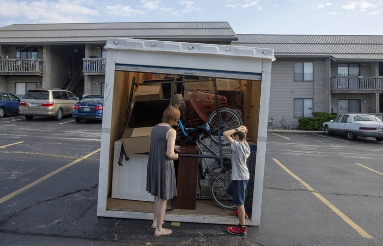 Lisa and Ralphie open up the moving container filled with their belongings. MUST CREDIT: Washington Post photo by Tristen Rouse