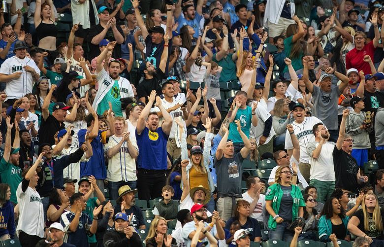 Mariners fans get on their feet to cheer Jake Fraley’s solo home run in the 5th inning.  The Texas Rangers played the Seattle Mariners in Major League Baseball Friday, July 2, 2021 – the first home game played since pandemic restrictions were lifted. 217555