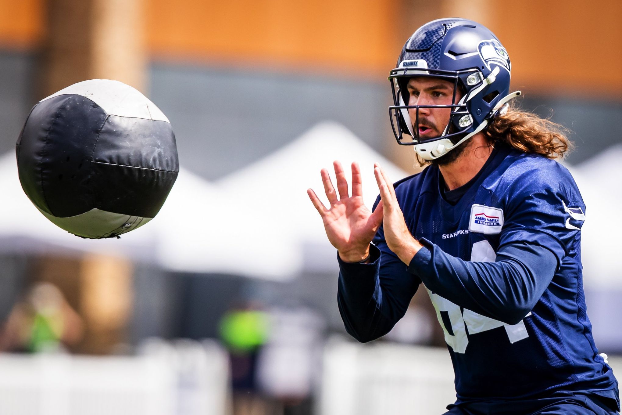 Seattle Seahawks tight end Colby Parkinson (84) puts his helmet on during  an NFL football game against the Los Angeles Chargers, Sunday, Oct. 23,  2022, in Inglewood, Calif. (AP Photo/Kyusung Gong Stock