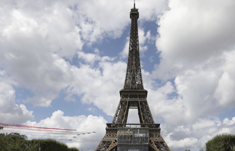 The French Aerial Patrol fly by the Eiffel Tower in Paris, Sunday, Aug. 8, 2021. Celebrations were held in Paris Sunday as part of the handover ceremony of Tokyo 2020 to Paris 2024, as Paris will be the next Summer Games host in 2024. The passing of the hosting baton will be split between the Olympic Stadium in Tokyo and a public party and concert in Paris. (AP Photo/Adrienne Surprenant) VLM123 VLM123