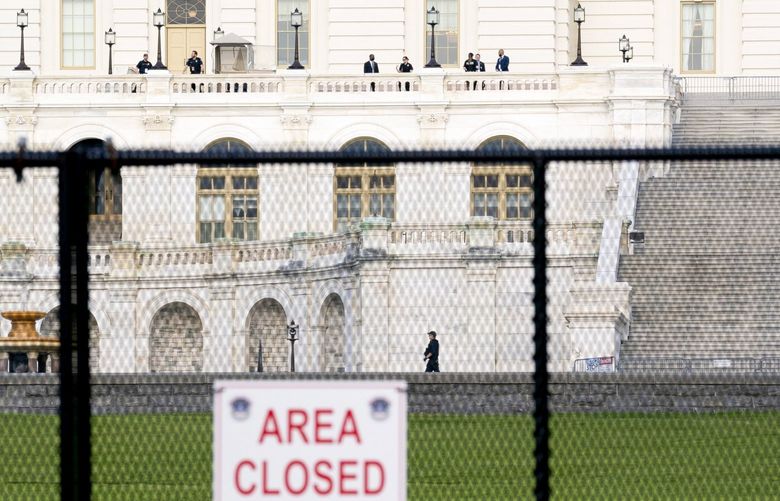 Temporary security fencing surrounds the U.S. Capitol as security personnel line the west front in Washington, D.C., U.S., on Wednesday, April 28, 2021. Biden will unveil a sweeping $1.8 trillion plan to expand educational opportunities and child care for families, funded in part by the largest tax increases on wealthy Americans in decades, the centerpiece of his first address to Congress. Photographer: Stefani Reynolds/Bloomberg 775649794