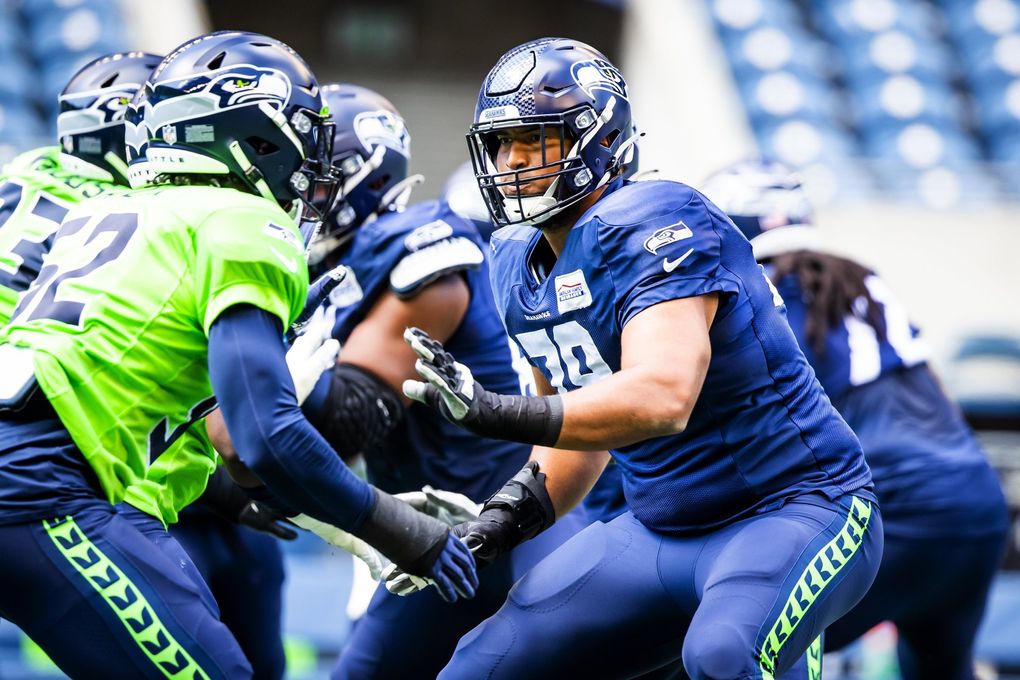 Seahawks offensive tackle Stone Forsythe warms up with the offensive line before a mock game at Lumen Field in Seattle, Aug. 8, 2021. (Bettina Hansen / The Seattle Times)