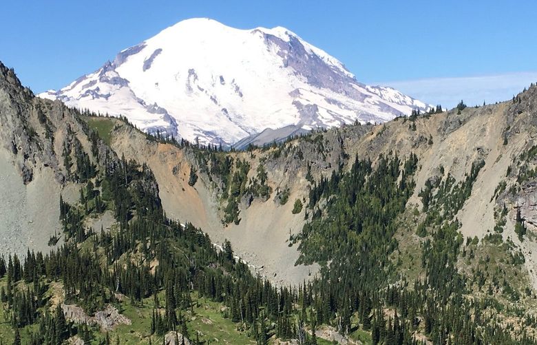 Crystal Lake is a picturesque alpine lake guarded by jagged-edged ridges with excellent views of Mount Rainier.