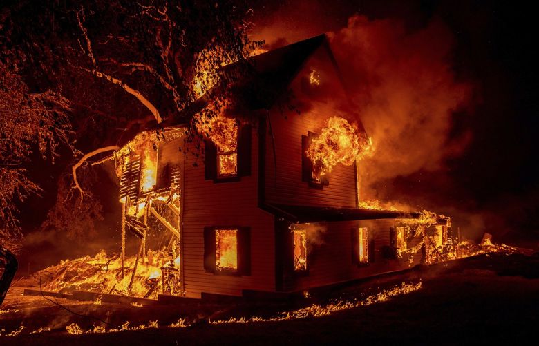 A home burns on Jeters Road as the Dixie fire jumps Highway 395 south of Janesville, Calif., on Monday, Aug. 16, 2021. Critical fire weather throughout the region threatens to spread multiple wildfires burning in Northern California. (AP Photo/Ethan Swope) BKWS307 BKWS307