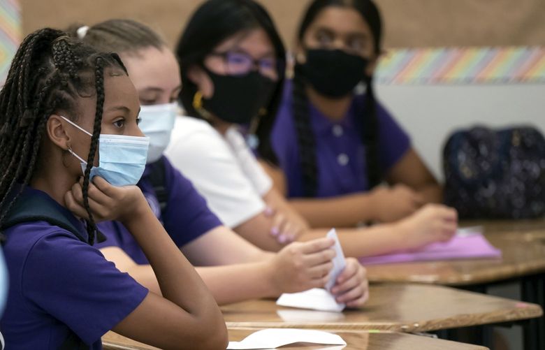 Students sit in a classroom at the Girls Academic Leadership Academy in Los Angeles, Monday, Aug. 16, 2021. Monday was the first day of in-classroom school in the Los Angeles Unified School District. For some students, this was their first time on campus in more than a year. (David Crane/The Orange County Register via AP) CAANR123 CAANR123