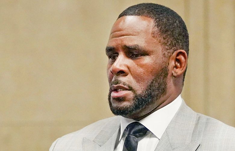 FILE – In this June 6, 2019, file photo, singer R. Kelly pleaded not guilty to 11 additional sex-related felonies during a court hearing before Judge Lawrence Flood at Leighton Criminal Court Building in Chicago. R&B singer R. Kelly is due in federal court to enter a plea to an updated federal indictment that includes sex abuse allegations involving a new accuser.  The 53-year-old is expected to plead not guilty at a hearing Thursday, March 5, 2020, in Chicago to a superseding indictment unsealed last month that includes multiple counts of child pornography. (E. Jason Wambsgans/Chicago Tribune via AP, Pool, File) NYHK302