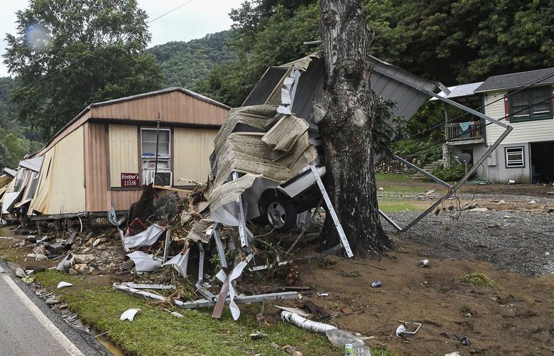 Wreckage from homes in Cruso, N.C., washed up along the roadways on Thursday after Tropical Depression Fred decimated the area.  Now as a post-tropical cyclone, Fred is drenching New York and New England. (Maya Carter/The Asheville Citizen-Times via AP) NCASH105 NCASH105