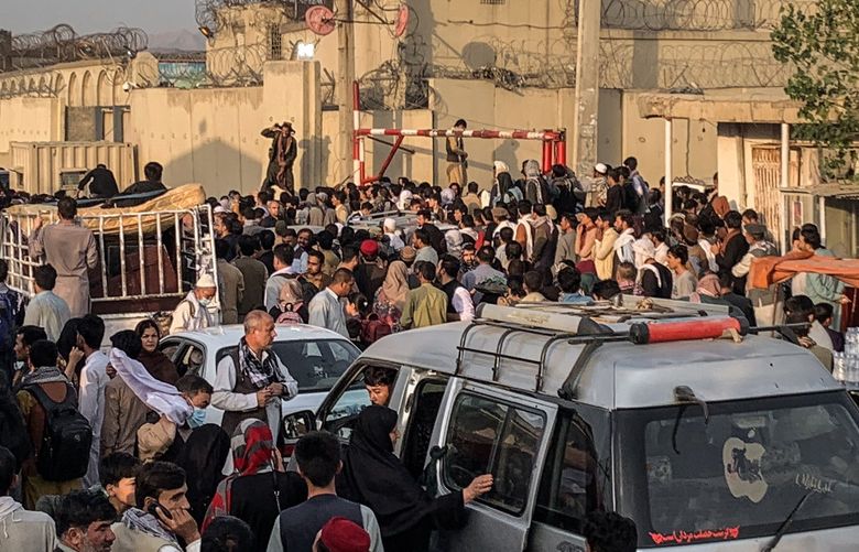 Hoping to flee the country, people gather near the airport in Kabul, Afghanistan on Saturday, Aug. 21, 2021. The U.S. Embassy in Kabul warned Americans to stay away from the Afghan capital’s airport on Saturday because of “potential security threats outside the gates,†in a sign of growing volatility at the choke point for thousands of Afghans desperate to escape the country’s new Taliban rulers. (Jim Huylebroek/The New York Times) XNYT36 XNYT36