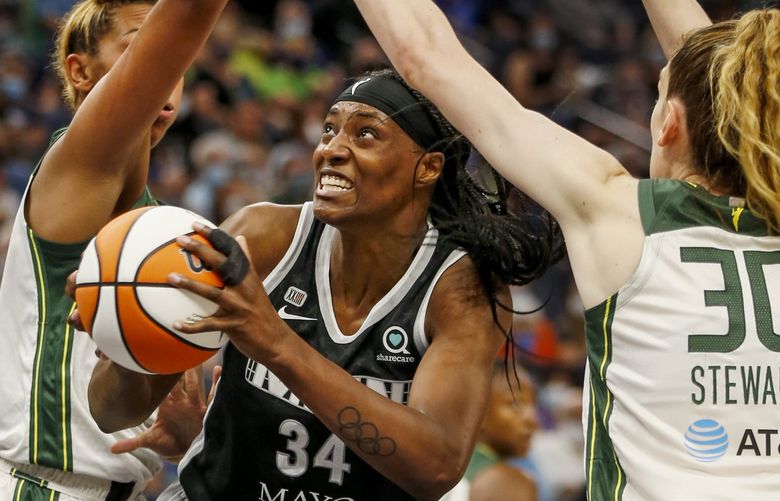 Minnesota Lynx center Sylvia Fowles (34) goes to the basket between Seattle Storm center Mercedes Russell and forward Breanna Stewart (30) in the second quarter of a WNBA basketball game Tuesday, Aug. 24, 2021, in Minneapolis. (AP Photo/Bruce Kluckhohn) MNBK101 MNBK101