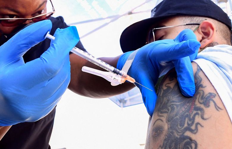 Nurse Eon Walk administers the Pfizer Covid-19 vaccine at a mobile vaccine clinic hosted by Mothers in Action and operated by the Los Angeles County of Public Health on July 16, 2021 in Los Angeles, California. –  (FREDERIC J. BROWN/AFP via Getty Images/TNS) 25131235W 25131235W