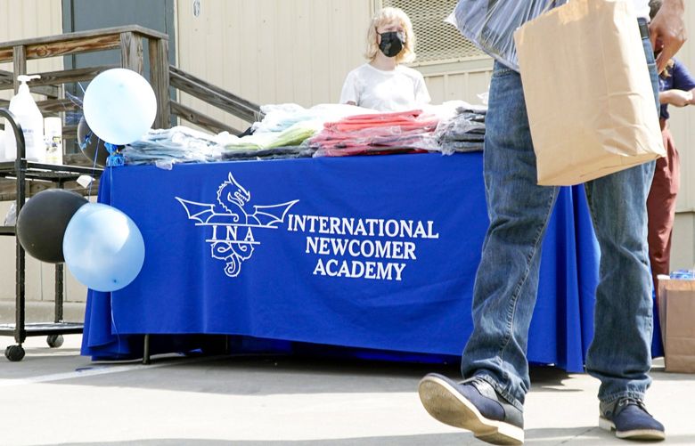 Families at the International Newcomer Academy picked up backpacks and other school supplies at the campus’ Back to School Drive in Fort Worth, Texas, on Aug. 14. The school not only provides an intense language and educational support for children new to the United States, but it also helps families who are dealing with trauma, financial strain or other challenges. DMN2108142015146306