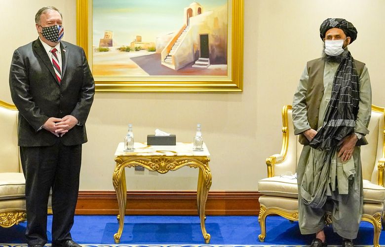 FILE – In this Nov. 21, 2020 file photo, Secretary of State Mike Pompeo meets with Mullah Abdul Ghani Baradar, head of the Taliban’s peace negotiation team, amid talks between the Taliban and the Afghan government, in Doha, Qatar. Baradar, the Taliban’s top political leader, who made a triumphal return to Afghanistan this week, battled the U.S. and its allies for decades but then signed a landmark peace agreement with the Trump administration. Baradar is now expected to play a key role in negotiations between the Taliban and officials from the Afghan government that the insurgents deposed in their blitz across the country. (AP Photo/Patrick Semansky, Pool, File) CAITH105