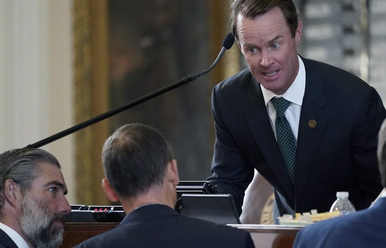 Speaker of the House Dade Phelan, R-Orange, top center, talks with Rep. Andrew Murr, R-Kerrville, center, as the House debates election bill SB1, Thursday, Aug. 26, 2021, in Austin, Texas. (AP Photo/Eric Gay) TXEG127 TXEG127