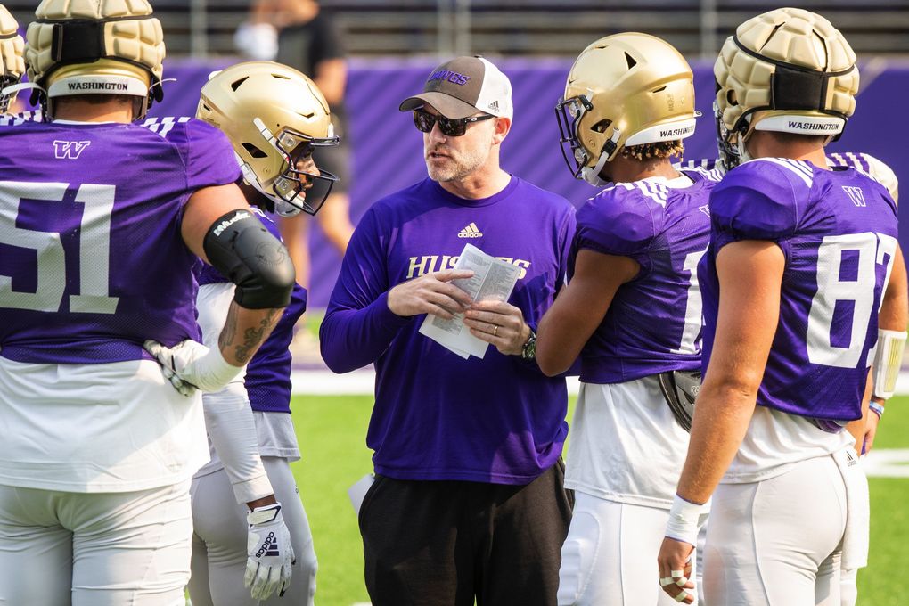 Offensive coordinator and quarterbacks coach John Donovan works with the offense as the University of Washington Huskies practice during fall camp in Seattle, Aug. 14, 2021. (Bettina Hansen / The Seattle Times)