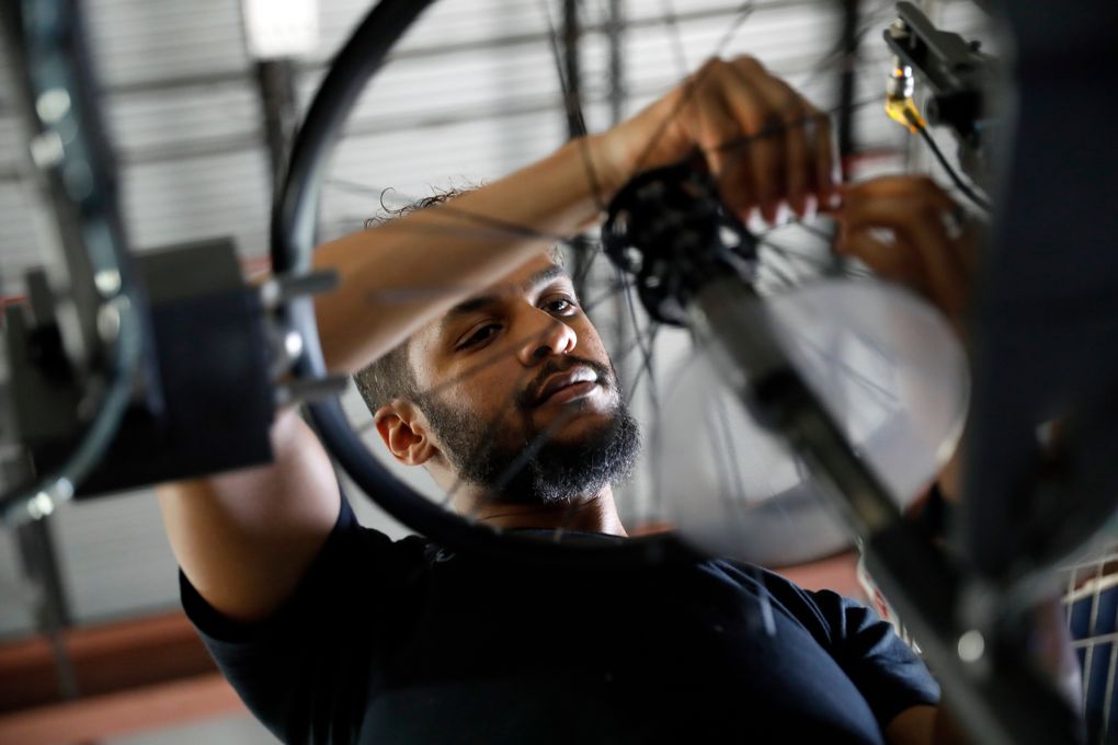 Chris Miller assembles a wheel at the Catrike workshop in Orlando, Fla., on June 25. The company thinks that sorting out its supply issues could take 12 to 18 months. (Octavio Jones / The New York Times)