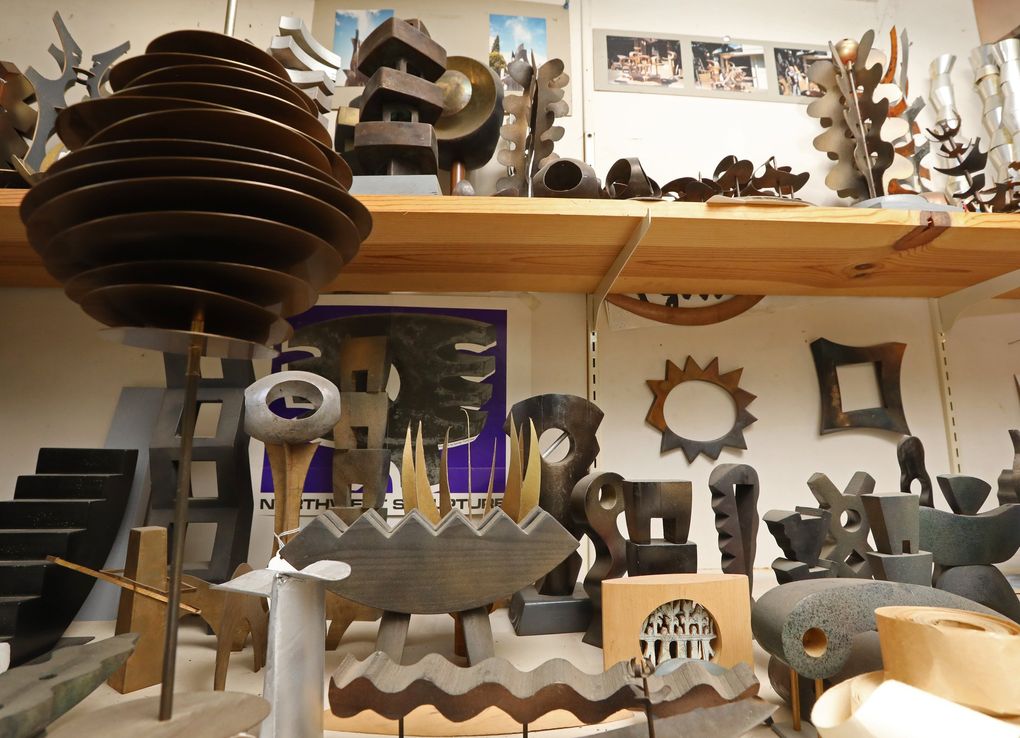 Models for larger works by both Gerard Tsutakawa (mostly below) and his father, George Tsutakawa (mostly above), are seen inside Tsutakawa’s home Wednesday, Aug. 18, 2021, in Seattle. (Ken Lambert / The Seattle Times)