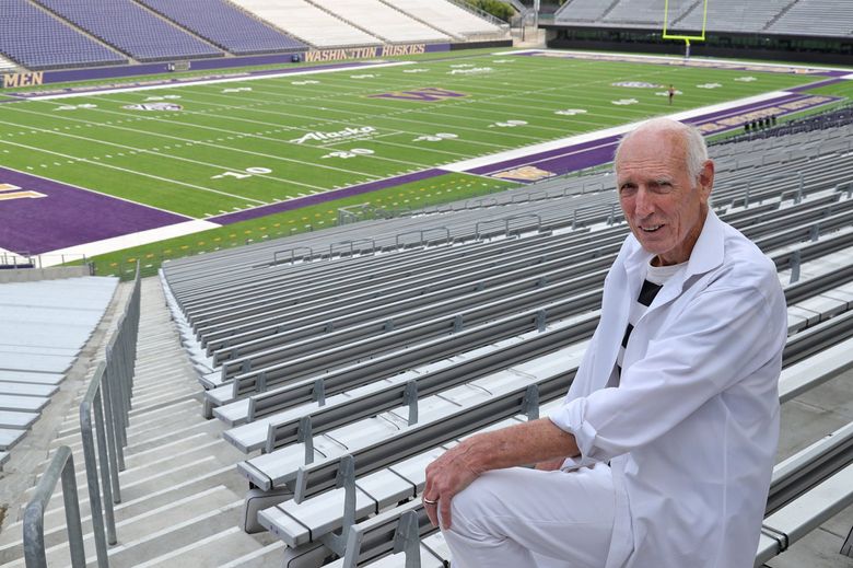 Seated in Husky Stadium, Phil Shinnick, 78, works full-time as an acupuncturist in New York. Shinnick has seen justice served 58 years after his world record in the long jump was denied.(Greg Gilbert / The Seattle Times)
