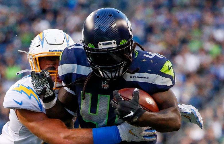 Lumen Field, Seattle, Wash. – Seattle Seahawks vs. Los Angeles Chargers preseason – 082821

Seattle Seahawks running back Alex Collins tries to push past Los Angeles Chargers linebacker Cole Christiansen  during the first quarter Saturday, Aug. 28, 2021, in Seattle. 218070