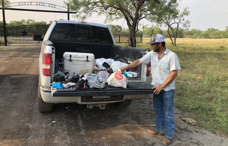 Ranch manager Cole Hill retrieves migrant trash north of the border near Uvalde, Texas.  (Molly Hennessy-Fiske/Los Angeles Times/TNS) 23644611W 23644611W