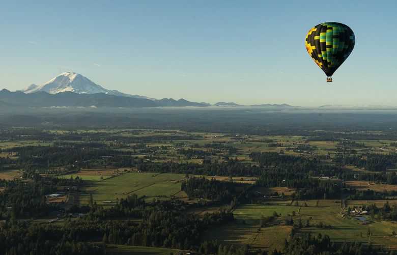 A sunrise flight over Enumclaw, Wash. on July 22, 2021. Ballooning had its heyday in the 70s but a new program in Washington State aims to introduce the aging sport to a new — and more diverse — class of aeronauts. (Ruth Fremson/The New York Times)