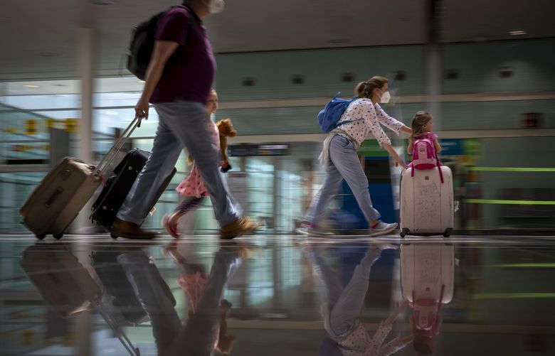 Tourists arrive at Barcelona airport, Spain, Monday, June 7, 2021. Spain is trying to ramp up its tourism industry by welcoming from Monday vaccinated visitors from most countries, as well as all Europeans who prove that they are not infected with the coronavirus. (AP Photo/Emilio Morenatti)