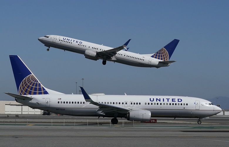 FILE – In this Oct. 15, 2020, file photo, a United Airlines airplane takes off over a plane on the runway at San Francisco International Airport in San Francisco.   (AP Photo/Jeff Chiu, File)