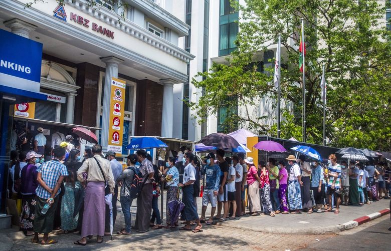 FILE – A line to withdraw cash from a bank in Yangon, Myanmar, March 22, 2021. Myanmar has been crippled by a cash shortage since the military seized power six months ago, plunging the Southeast Asian nation into a financial crisis. (The New York Times) XNYT50 XNYT50
