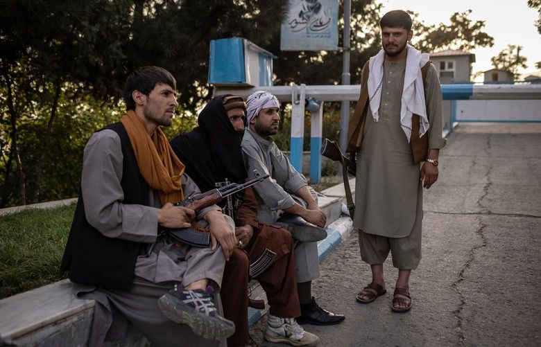 Armed men with Taliban members, center, in Kabul, Afghanistan on Aug. 15, 2021. Even as President Joe Biden was telling the public that Kabul was unlikely to fall, intelligence assessments painted a grimmer picture. (Jim Huylebroek/The New York Times) XNYT37 XNYT37