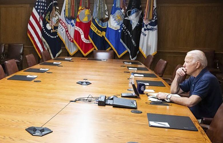 In this photo released by The White House, President Joe Biden meets virtually with his national security team and senior officials for a briefing on Afghanistan, Sunday, Aug. 15, 2021, at Camp David, Md.  (The White House via AP) DCHO601 DCHO601