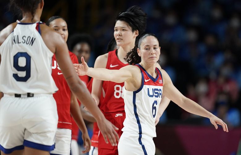 United States’ Sue Bird (6), right, celebrates with teammate A’Ja Wilson (9) at the halftime during women’s basketball gold medal game against Japan at the 2020 Summer Olympics, Sunday, Aug. 8, 2021, in Saitama, Japan. (AP Photo/Charlie Neibergall) OLYAR122 OLYAR122