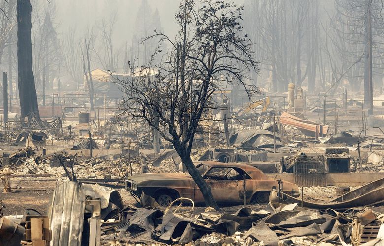Homes and cars destroyed by the Dixie Fire line central Greenville on Thursday, Aug. 5, 2021, in Plumas County, Calif. (AP Photo/Noah Berger) CANB117 CANB117