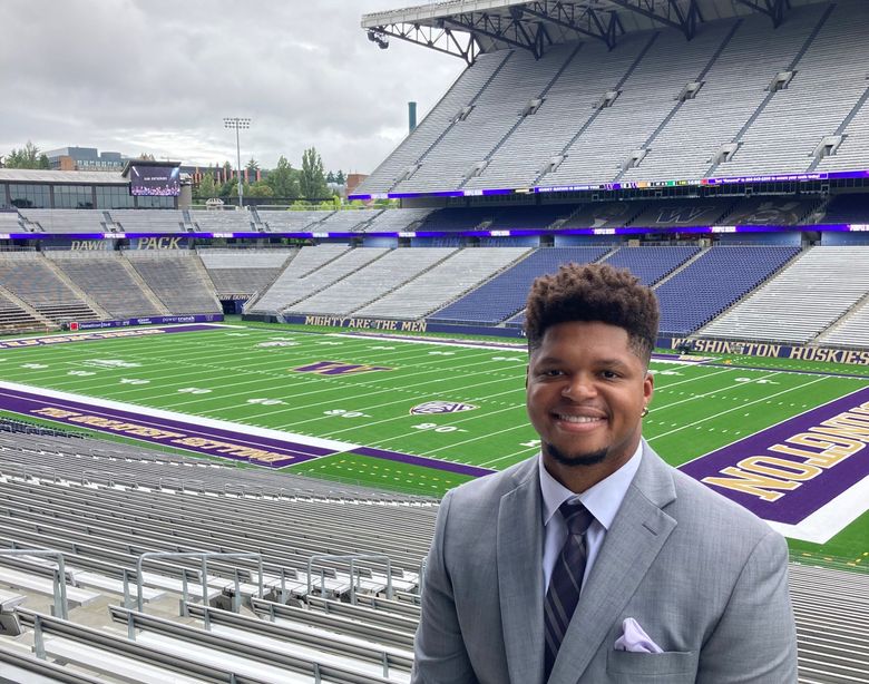 Former UW football player and current orthopedic surgeon Greg Walker Jr. poses in front of Husky Stadium this summer after completing UW Medicines orthopedic surgery residency program. (photo courtesy Greg Walker Jr.)