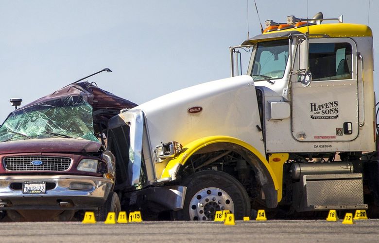 Investigators surround an SUV that was struck by a semitruck near the U.S.-Mexico border on March 2, 2021, in Holtville, California. (Gina Ferazzi/Los Angeles Times/TNS) 13587491W