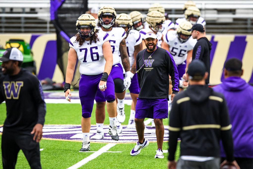 Huskies head football coach Jimmy Lake watches warmups for a scrimmage at Husky Stadium in Seattle, Aug. 21, 2021. (Bettina Hansen / The Seattle Times)