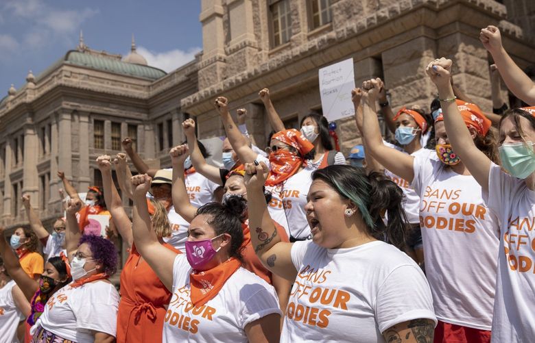 FILE – In this Sept. 1, 2021 file photo, women protest against the six-week abortion ban at the Capitol in Austin, Texas. Even before a strict abortion ban took effect in Texas this week, clinics in neighboring states were fielding more and more calls from women desperate for options. The Texas law, allowed to stand in a decision Thursday, Sept. 2, 2021 by the U.S. Supreme Court, bans abortions after a fetal heartbeat can be detected, typically around six weeks. (Jay Janner/Austin American-Statesman via AP File) TXAUS202 TXAUS202