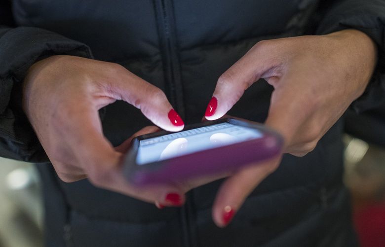 FILE — A commuter on her phone at Penn Station in New York, April 3, 2018. (Joshua Bright/The New York Times)